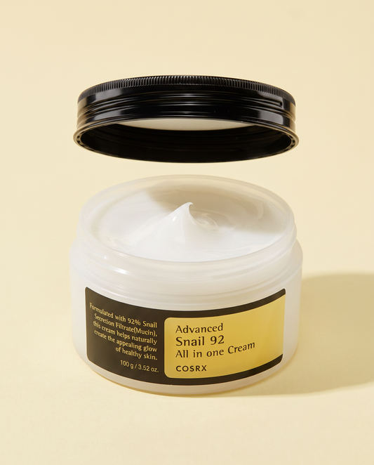 COSRX Advanced Snail 92 All In One Cream 100g - open black-lidded jar showing the cream, cream background