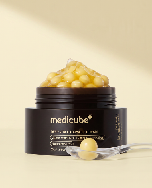 Medicube Deep Vita C Capsule Cream 55g - open black and gold jar of yellow capsules with a spatula