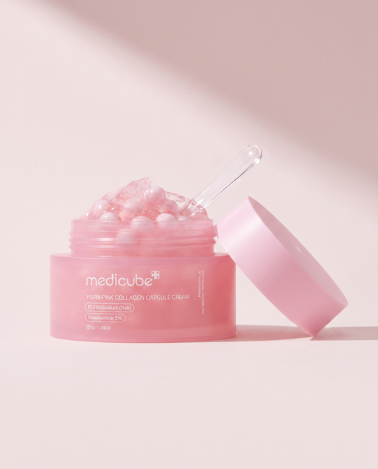 Medicube PDRN Pink Collagen Capsule Cream 55g - open pink jar with the lid propped beside it, pink background