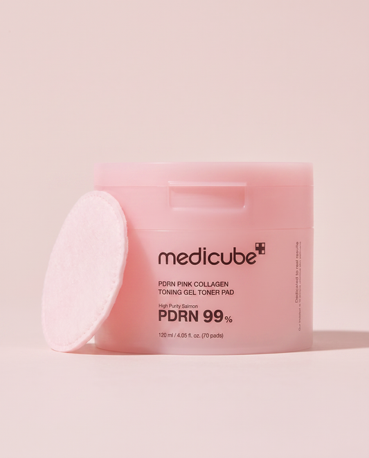 Medicube PDRN Pink Collagen Toner Pads 120ml - pink tub with a round toner pad leaning against it