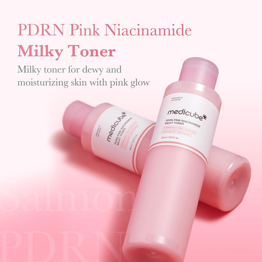 Two PDRN Pink Niacinamide Milky Toner bottles lying on a pink surface, a milky toner for dewy, moisturised skin