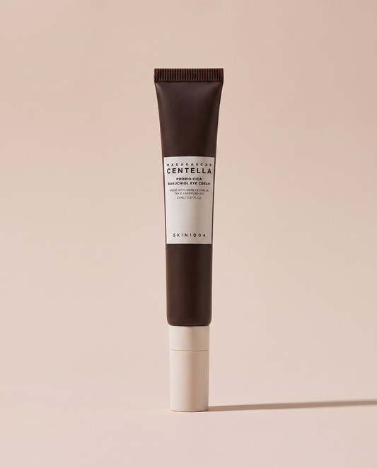 SKIN1004 Centella Bakuchiol Eye Cream 20ml - dark-capped tube on a dusty pink background