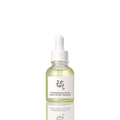 A glass dropper bottle of Calming Barrier Serum with green tea and panthenol, featuring a white label with Korean and English text, set against a clean off-white background with a soft reflection below.