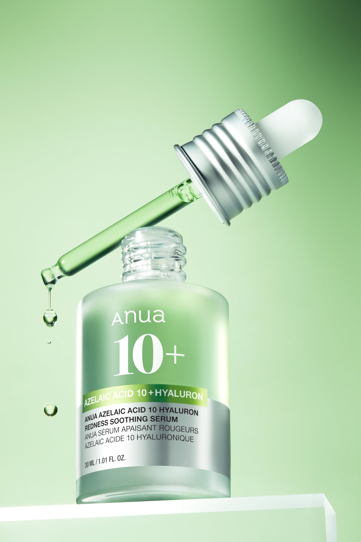 Anua Azelaic Acid 10% Soothing Serum 30ml - green ampoule bottle with the dropper above it, green background