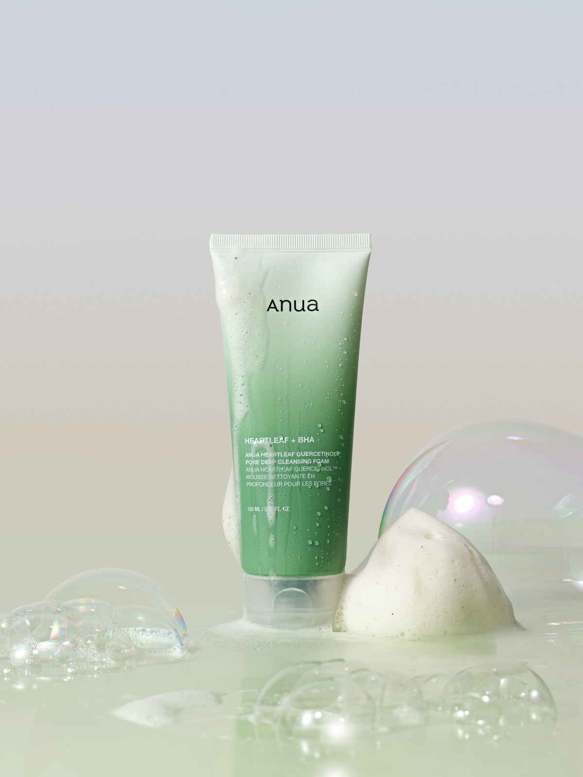 Anua Heartleaf Quercetinol Pore Deep Cleansing Foam 150ml - green cleansing foam tube among bubbles