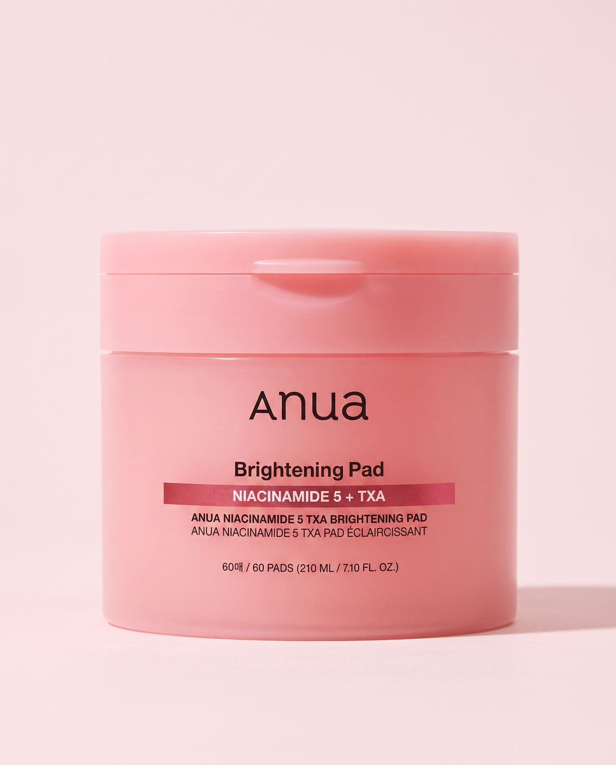 Anua Niacinamide 5% TXA Brightening Toner Pads 60 Pads - pink toner pad tub on a pink background