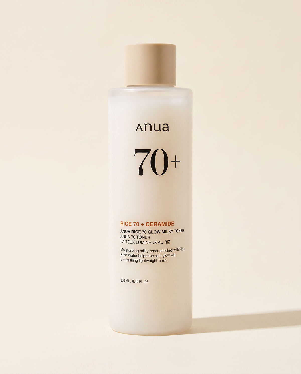 Anua Rice 70 Glow Milky Toner 250ml - cream toner bottle on a pale pink background