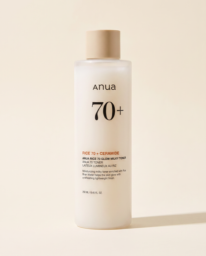 Anua Rice 70 Glow Milky Toner 250ml - cream toner bottle on a pale pink background