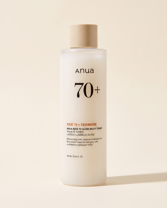 Anua Rice 70 Glow Milky Toner 250ml - cream toner bottle on a pale pink background