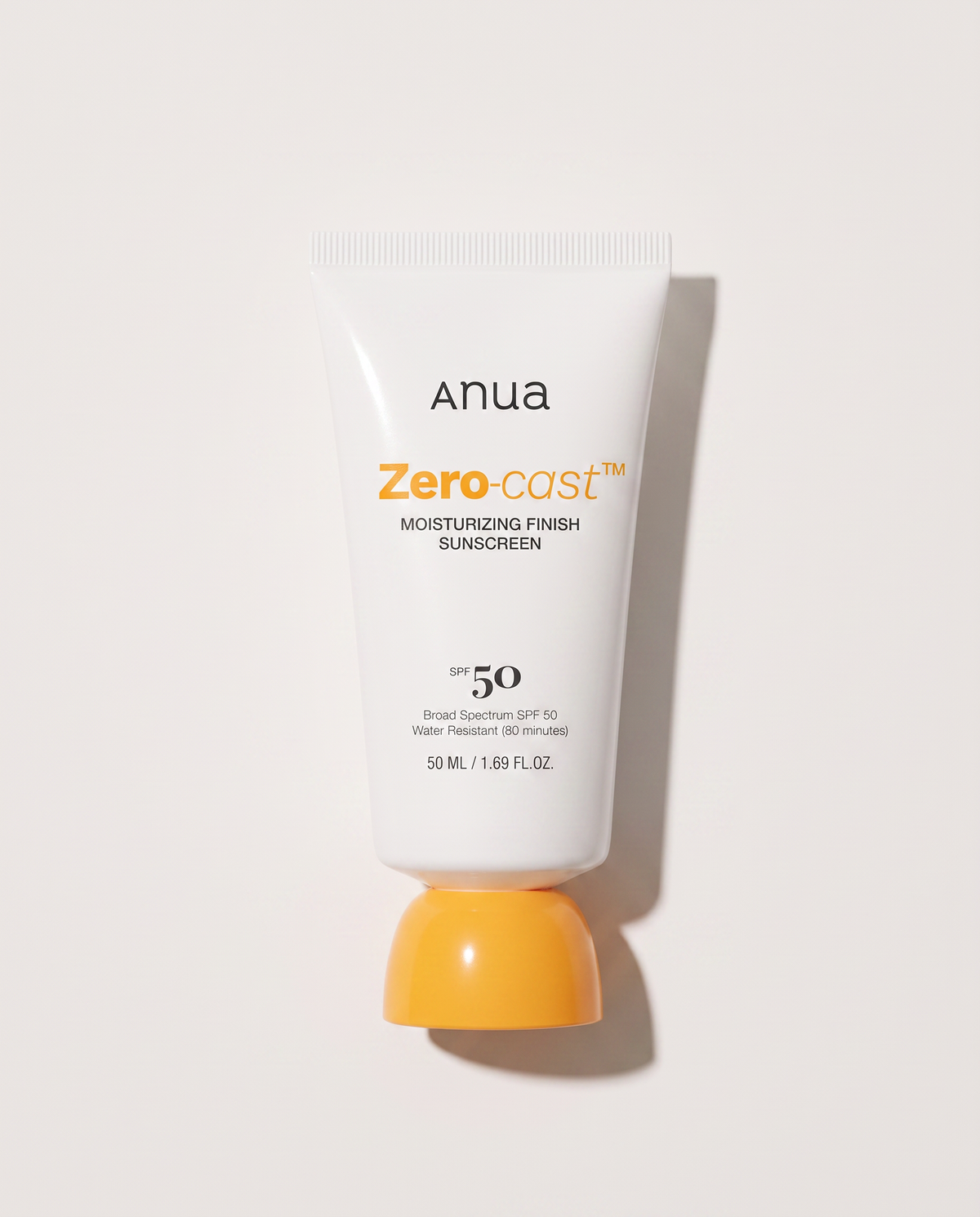 Anua Zero-Cast Sunscreen SPF50 50ml - sunscreen tube standing on its yellow cap, white background