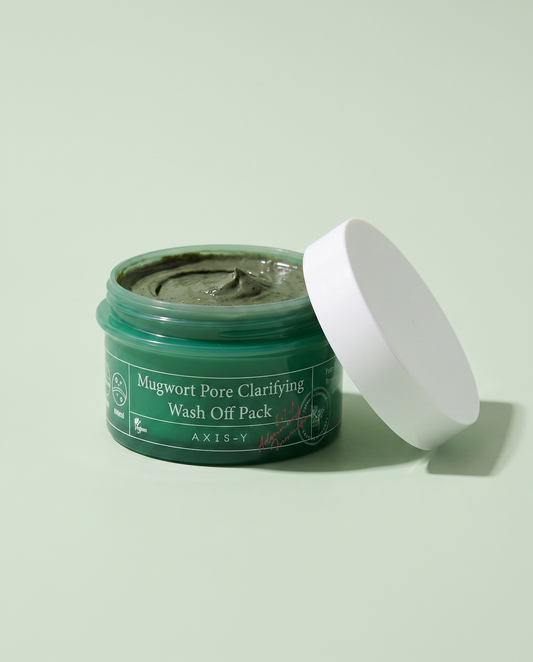 AXIS-Y Mugwort Pore Clarifying Mask 100ml - open green jar with the lid beside it, green background