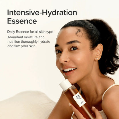 A smiling model holding the bottle: an intensive-hydration daily essence for all skin types that hydrates and firms