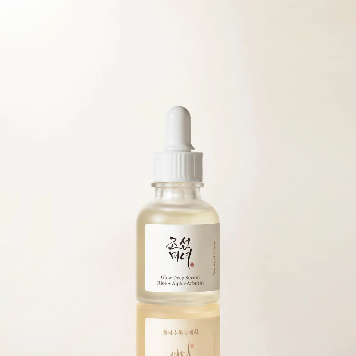 Beauty of Joseon Glow Deep Serum Rice + Arbutin 30ml - clear serum dropper bottle on a cream background