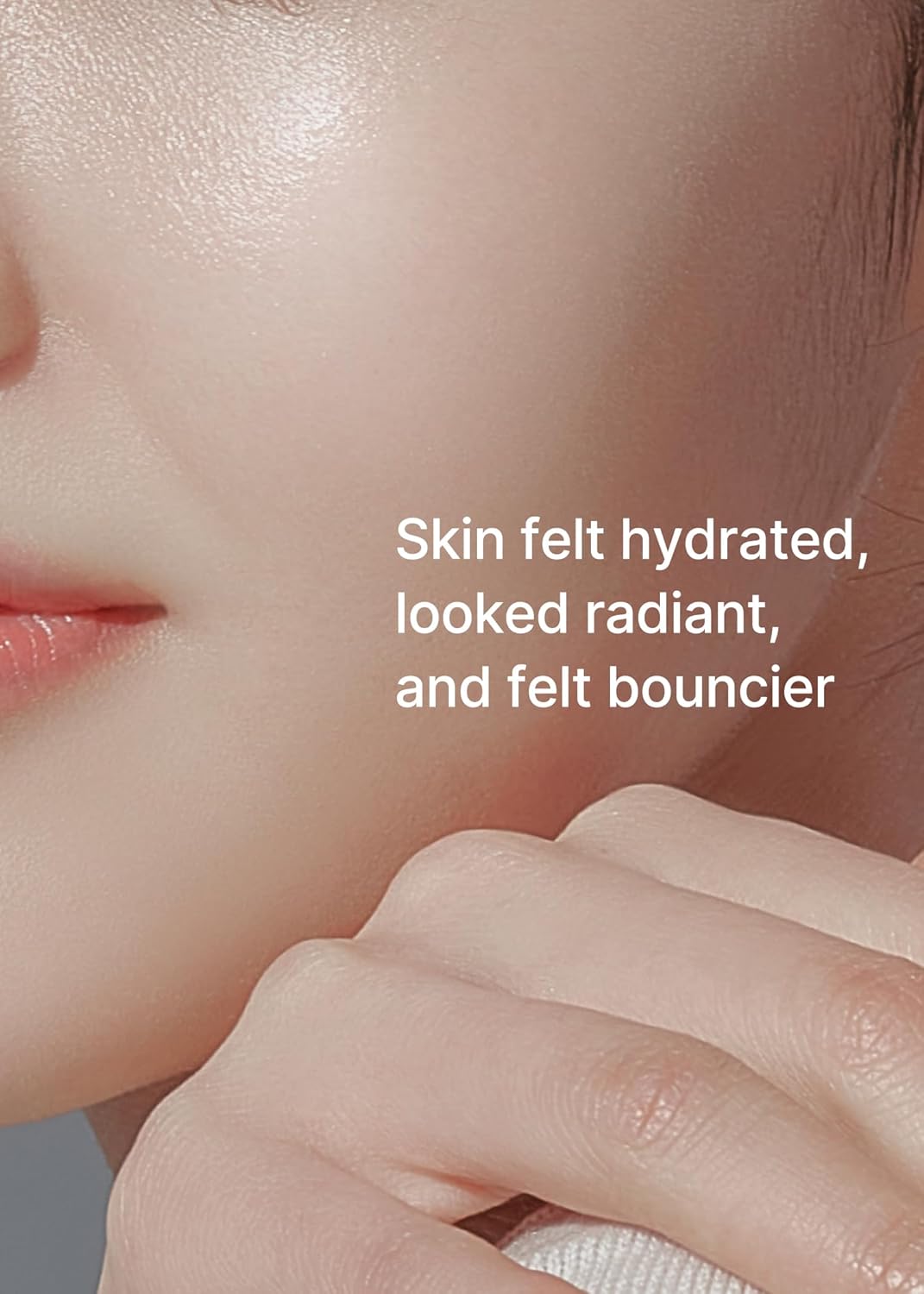A close-up of a model's cheek and hand: skin felt hydrated, looked radiant and felt bouncier