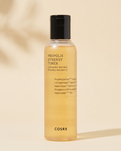 COSRX Full Fit Propolis Synergy Toner 150ml - amber toner bottle with a black cap on a peach background