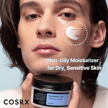 A model with cream on his cheek holding the jar: a non-oily moisturiser for dry, sensitive skin