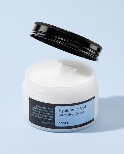 COSRX Hyaluronic Acid Intensive Cream 100g - black-lidded jar with the lid off, blue background