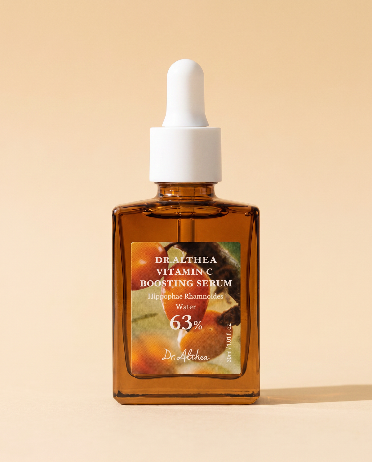 Dr.Althea Vitamin C Boosting Serum 30ml - amber glass dropper bottle on a warm orange background