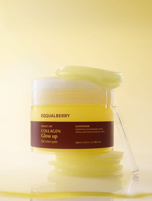 Eqqualberry Collagen Glow Toner Pads 60 Pads 140ml - jar with the spatula resting on the rim, yellow background