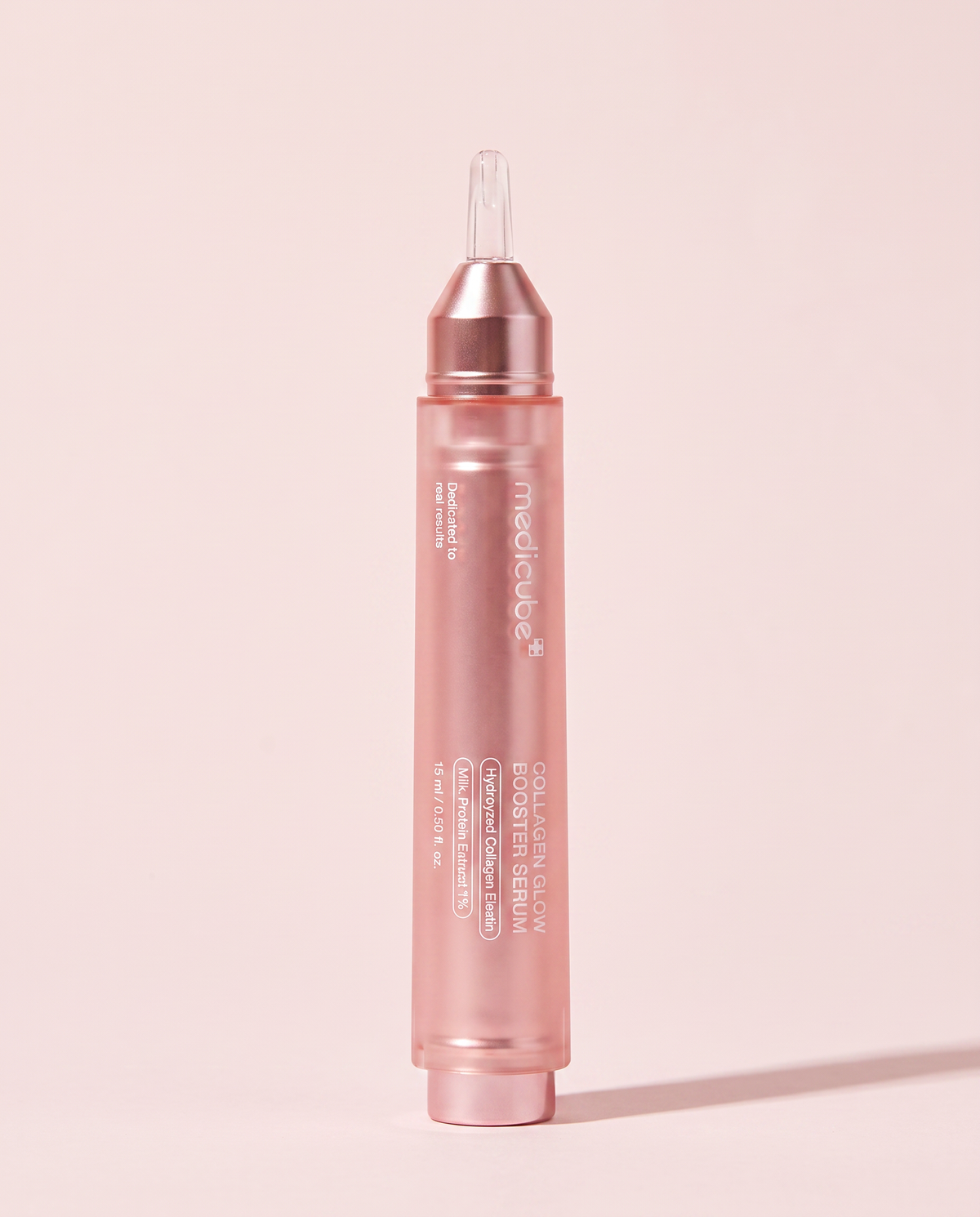 Medicube Collagen Glow Booster Serum 15ml - slim pink applicator pen on a pink background