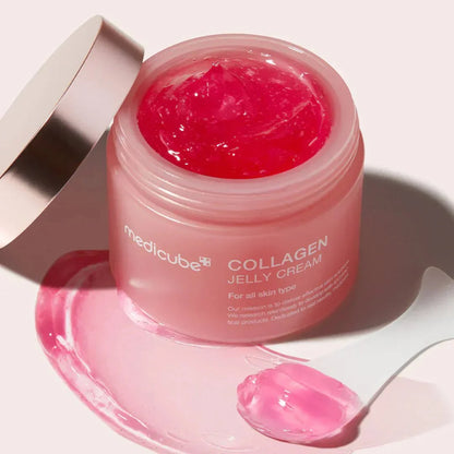 Open jar tilted to show the deep pink jelly, with a spatula holding a scoop of the product