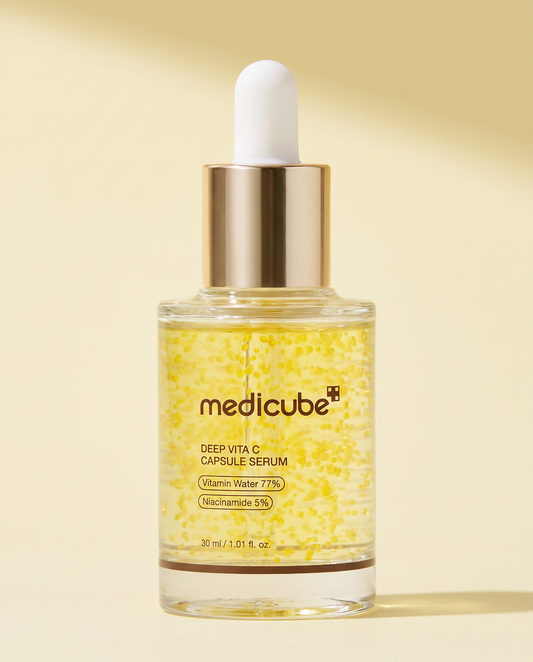 Medicube Deep Vita C Capsule Serum 30ml - gold-flecked dropper bottle on a pale yellow background
