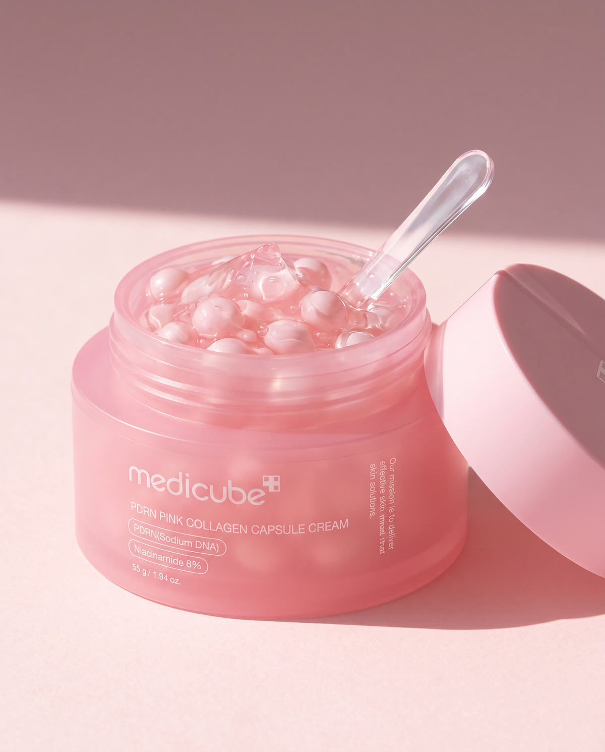 Medicube PDRN Pink Collagen Capsule Cream 55g - open pink jar of capsules with a spatula and the lid beside it