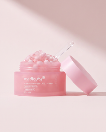 Medicube PDRN Pink Collagen Capsule Cream 55g - open pink jar with the lid propped beside it, pink background