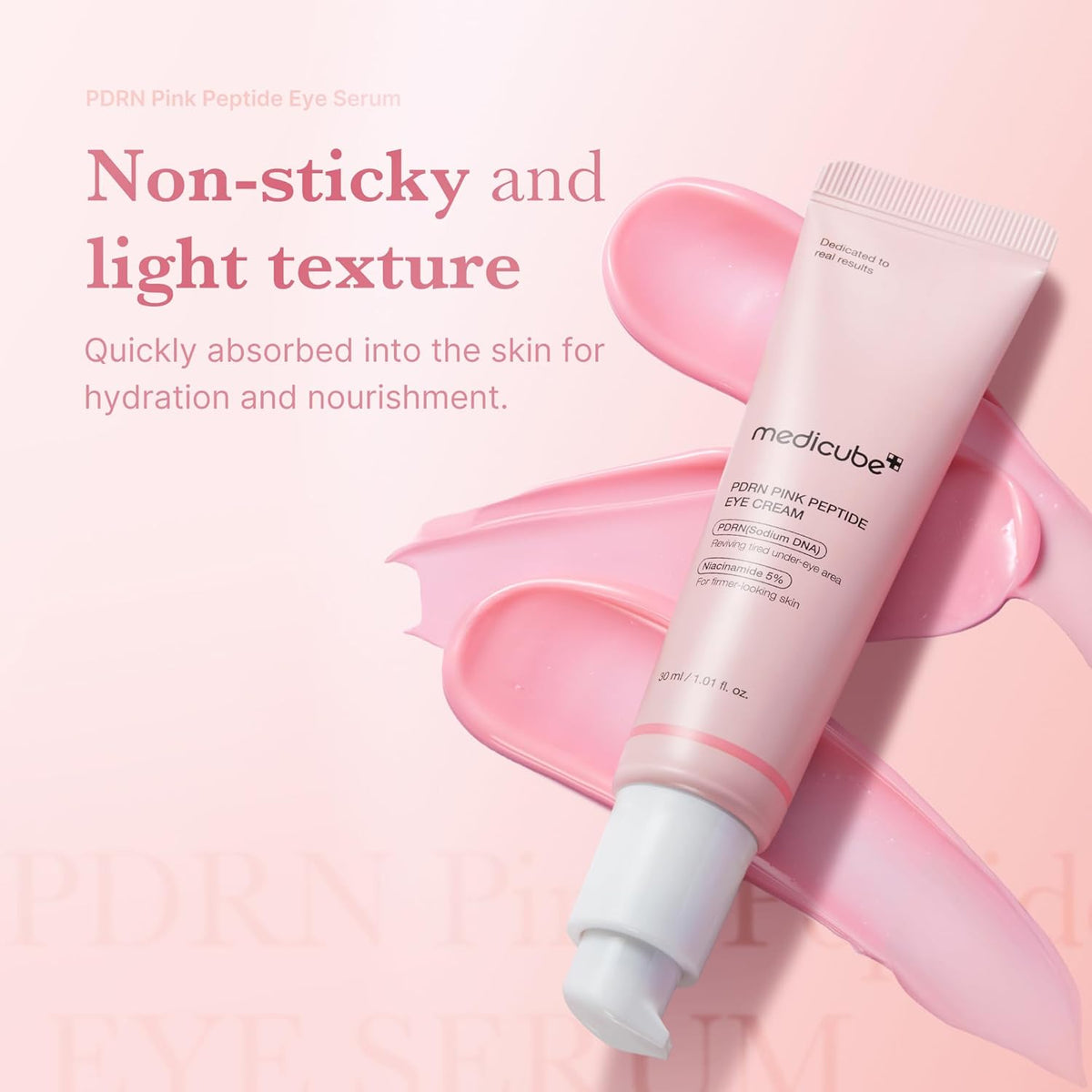 Non-sticky and light texture: the tube lying on a swipe of pink cream, quickly absorbed for hydration and nourishment