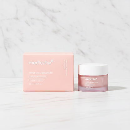 Triple Collagen Cream jar beside its peach outer carton on a marble surface