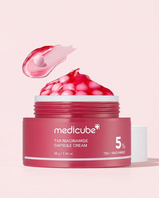 Medicube TXA Niacinamide Capsule Cream 55g - red jar topped with pink capsules and a cream swatch, pink background
