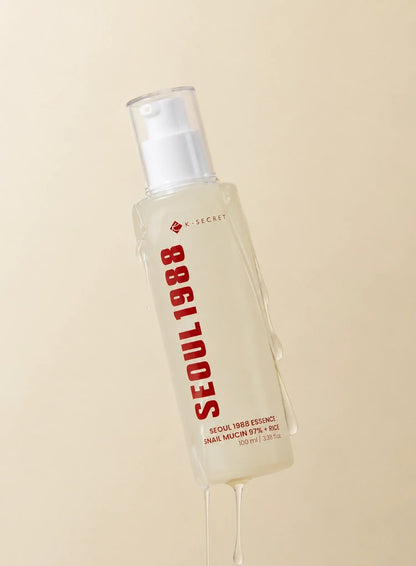 Seoul 1988 Snail Mucin Essence 100ml - pump bottle with a drip of the essence from the nozzle