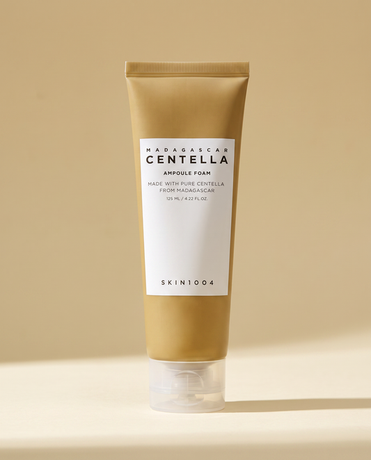 SKIN1004 Centella Ampoule Foam 125ml - tan ampoule foam tube on a warm gold background