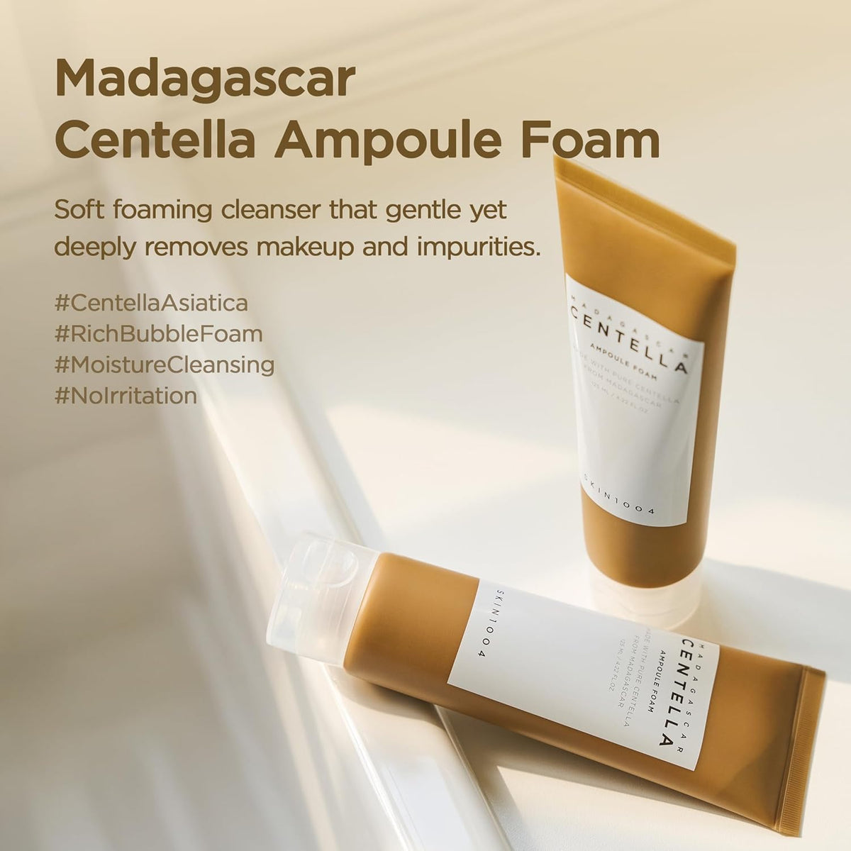 Two Madagascar Centella Ampoule Foam tubes on a bathtub edge, a soft foaming cleanser that removes make-up and impurities