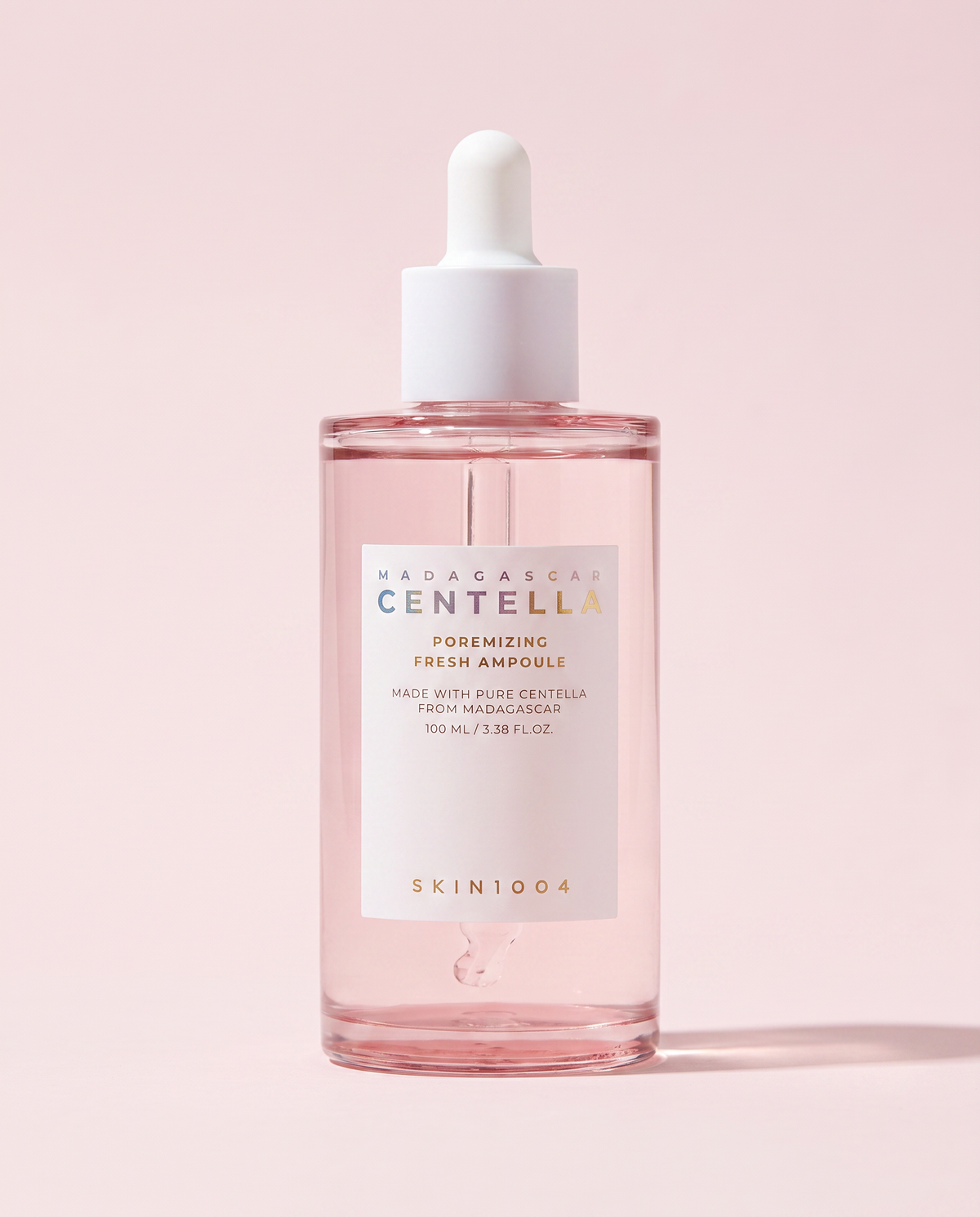 SKIN1004 Centella Poremizing Ampoule 100ml - pink ampoule bottle with a dropper on a pink background