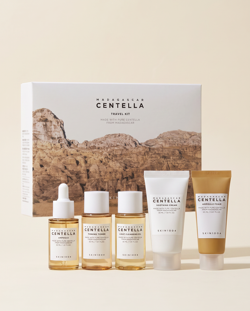 SKIN1004 Centella Travel Kit - travel kit with its outer box and a rock backdrop