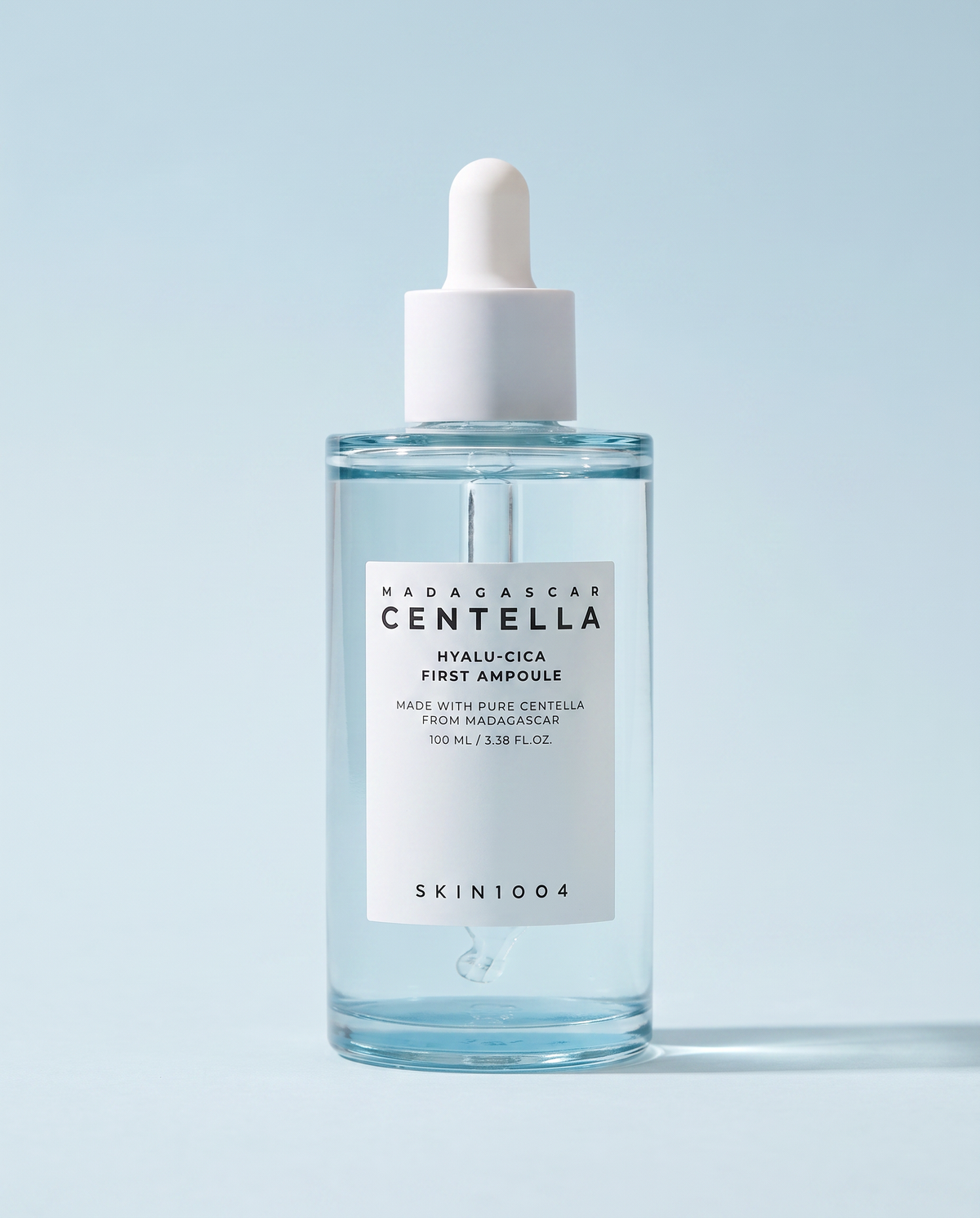 SKIN1004 Hyalu-Cica First Ampoule 100ml - clear ampoule bottle on a pale blue background