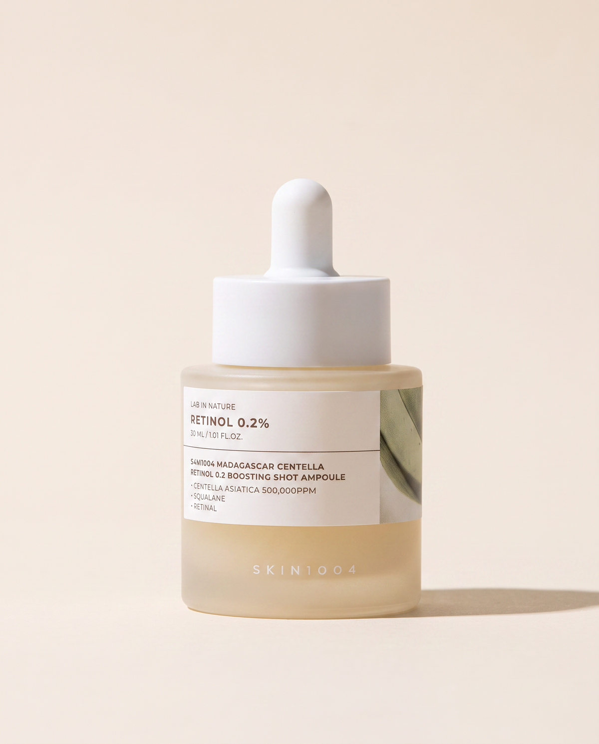 SKIN1004 Retinol 0.2% Boosting Ampoule 30ml - small cream bottle with a dropper on a beige background