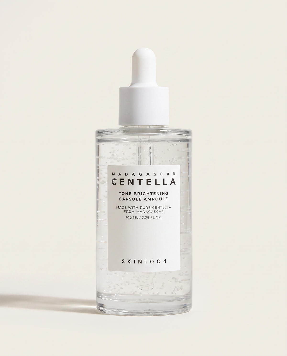 SKIN1004 Tone Brightening Capsule Ampoule 100ml - clear ampoule bottle on a cream background