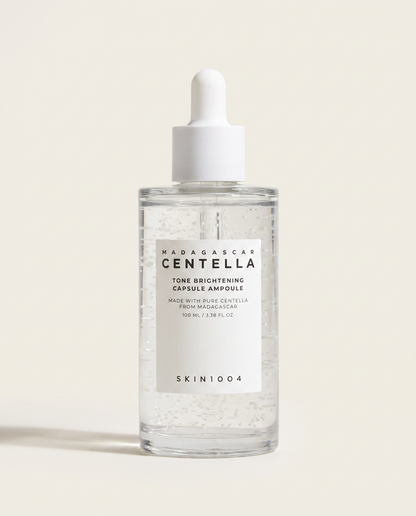 SKIN1004 Tone Brightening Capsule Ampoule 100ml - clear ampoule bottle on a cream background